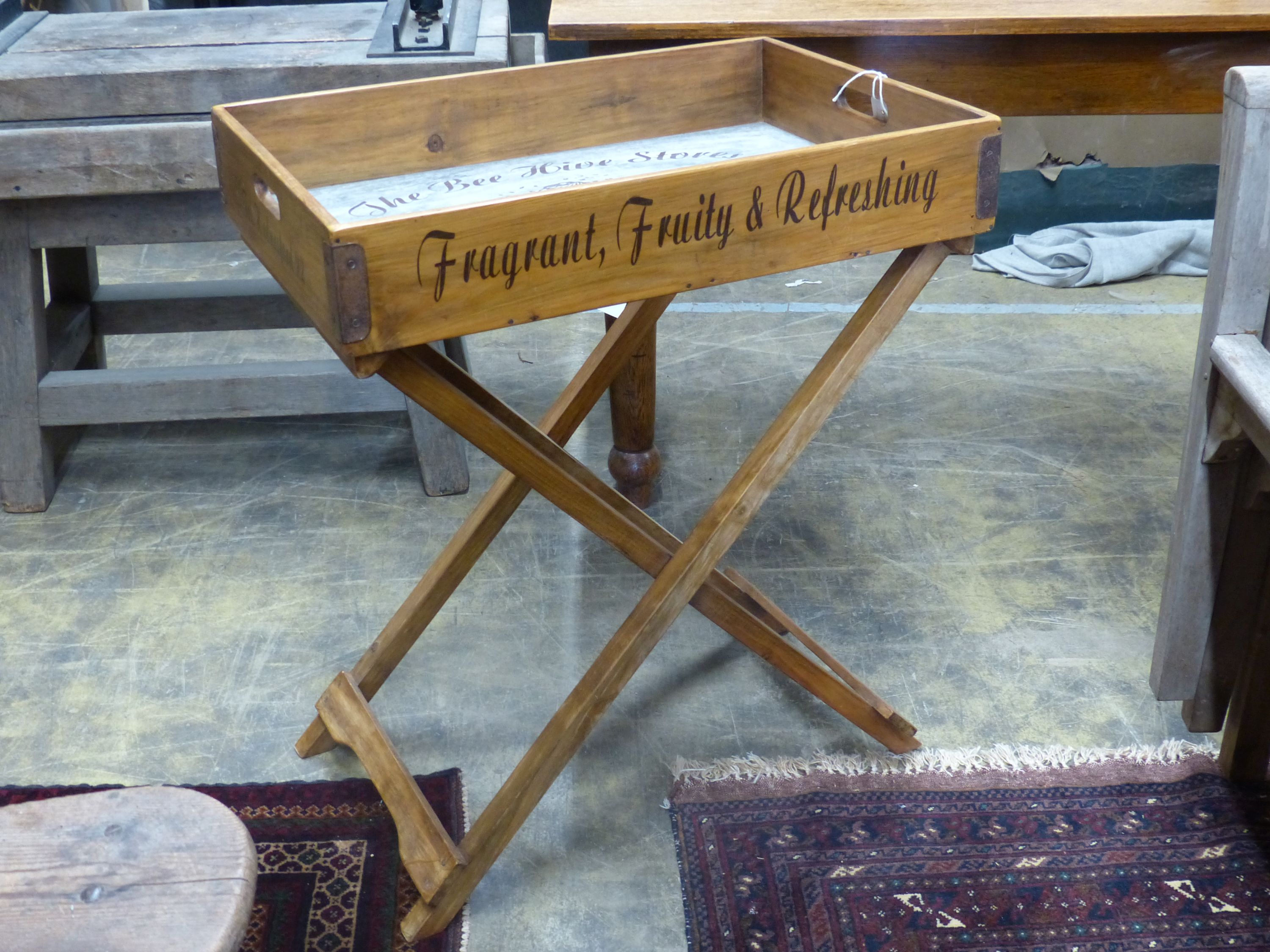 'The Bee Hive Stores', a rectangular wooden produce display tray on folding stand, width 65cm, depth 44cm, height 78cm